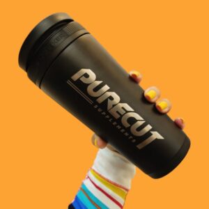 pure cut shaker PureCut Shaker held by hand on orange background