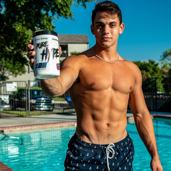 Masculine guy holding Pure Hype in front of a pool